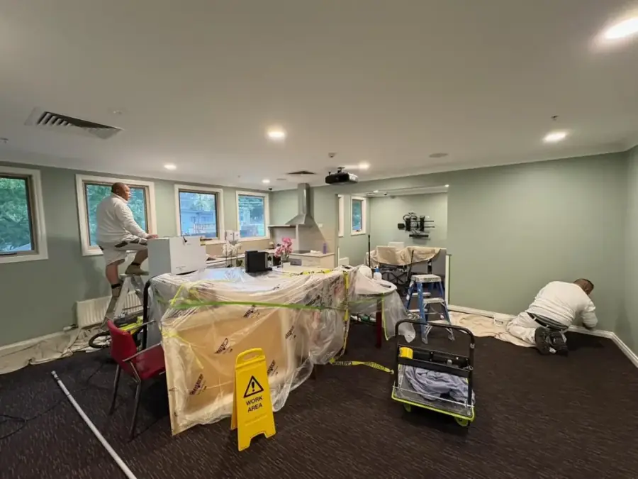 Painters applying exterior coatings on site