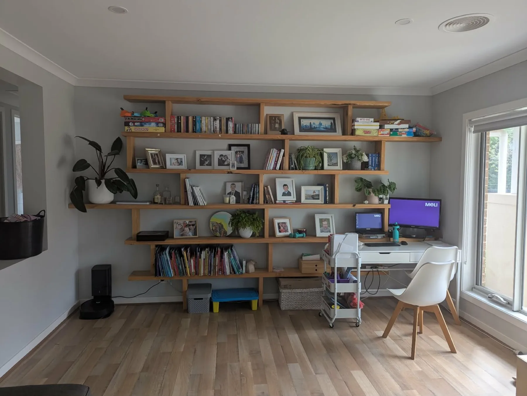 Old cluttered workspace with loaded pine shelves before cabinetry